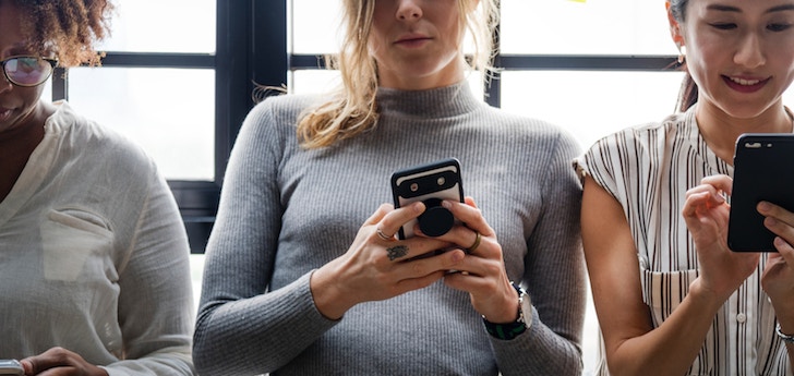 Women consulting their mobile phone